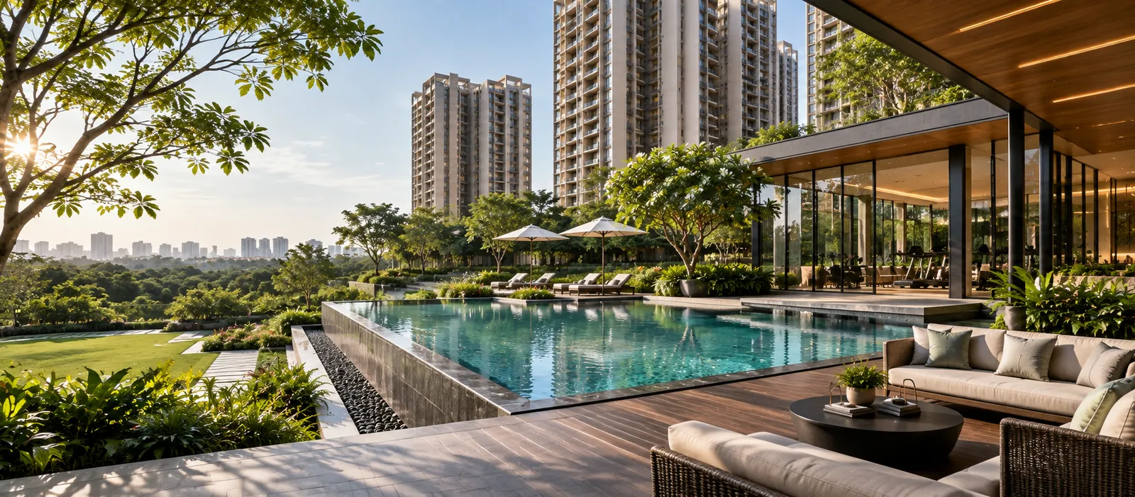 Shaded poolside lounge seating with timber deck and landscaped surroundings at Sattva Courtyard